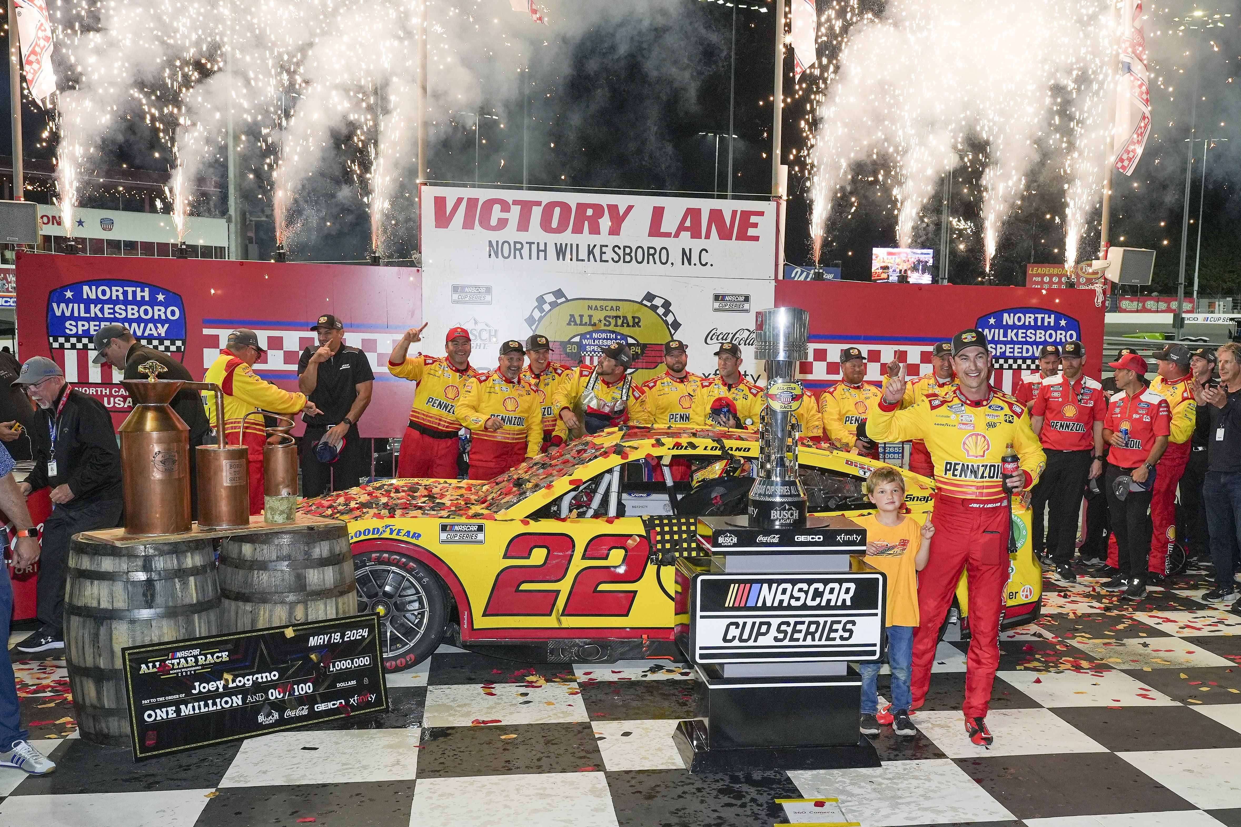 Joey Logano (22) celebrates his win with his team during the All-Star Race at North Wilkesboro Speedway. - Source: Imagn